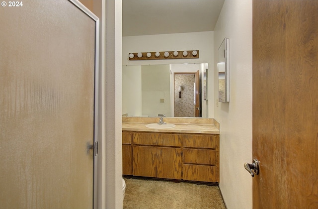 bathroom featuring vanity and an enclosed shower