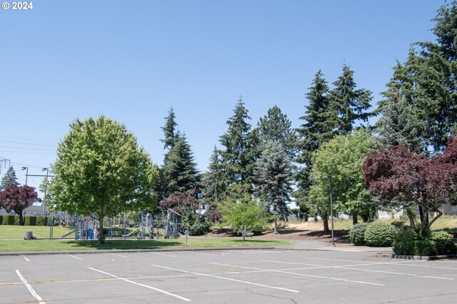 view of vehicle parking with a playground