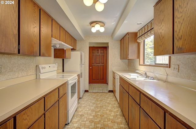 kitchen featuring white appliances and sink