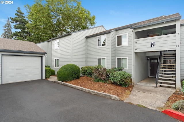 multi unit property featuring stairs and a garage