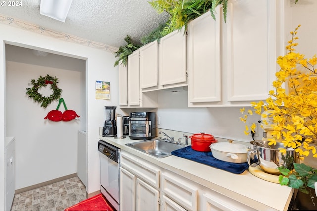 kitchen with white dishwasher, sink, white cabinetry, and a textured ceiling