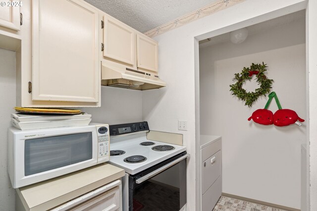 kitchen featuring a textured ceiling, washer / clothes dryer, white appliances, and white cabinets