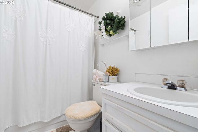 full bathroom with shower / bath combo, toilet, and vanity