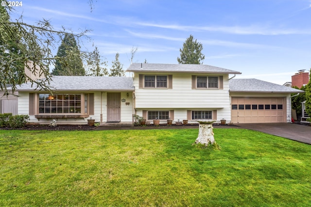 tri-level home with a garage and a front yard