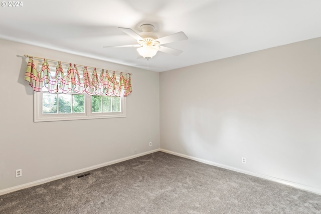 empty room featuring carpet floors and ceiling fan