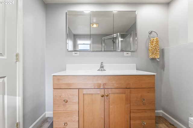 bathroom with hardwood / wood-style floors and vanity