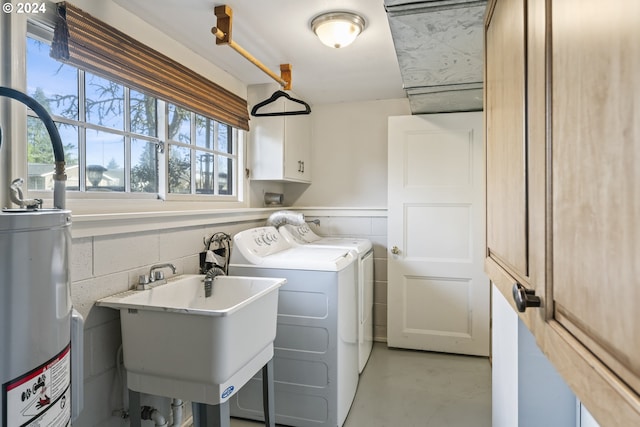 washroom featuring washer hookup, separate washer and dryer, cabinets, and sink