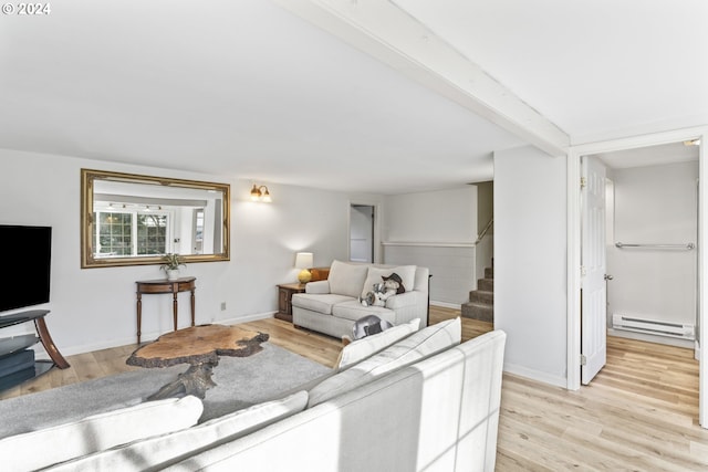 living room featuring beamed ceiling, light wood-type flooring, and a baseboard heating unit