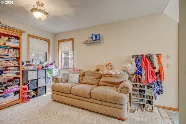 living room with a healthy amount of sunlight, light colored carpet, and lofted ceiling