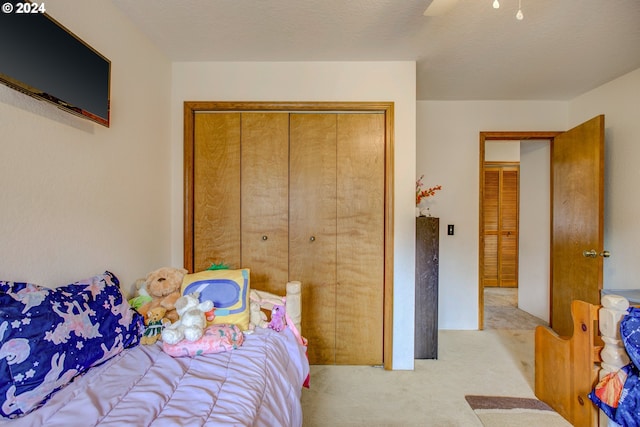 carpeted bedroom with a closet and ceiling fan