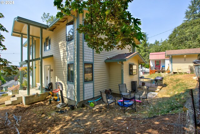 back of property featuring an outbuilding