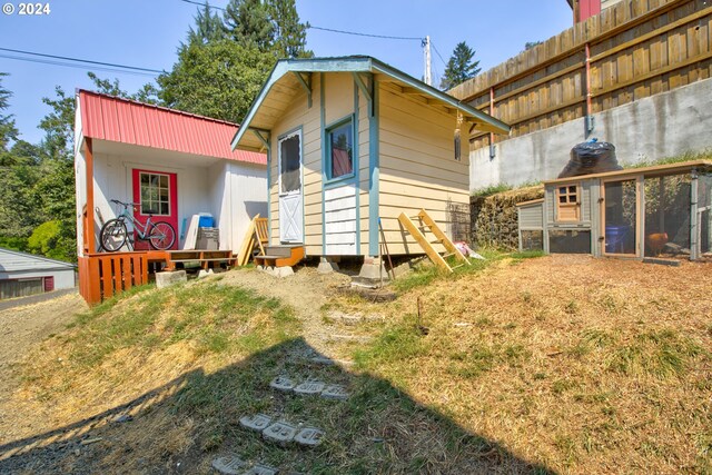 back of house with a balcony and a deck