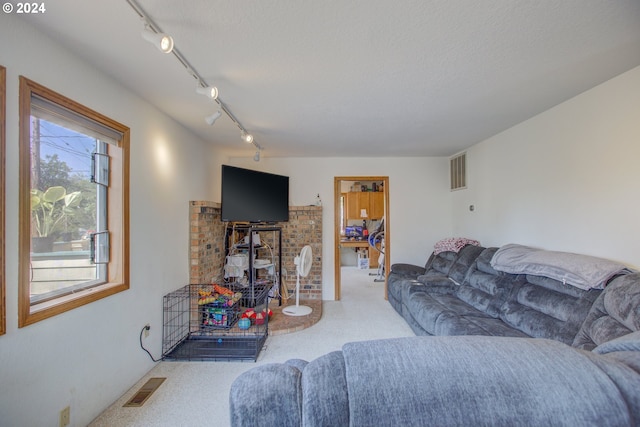 carpeted living room with a textured ceiling