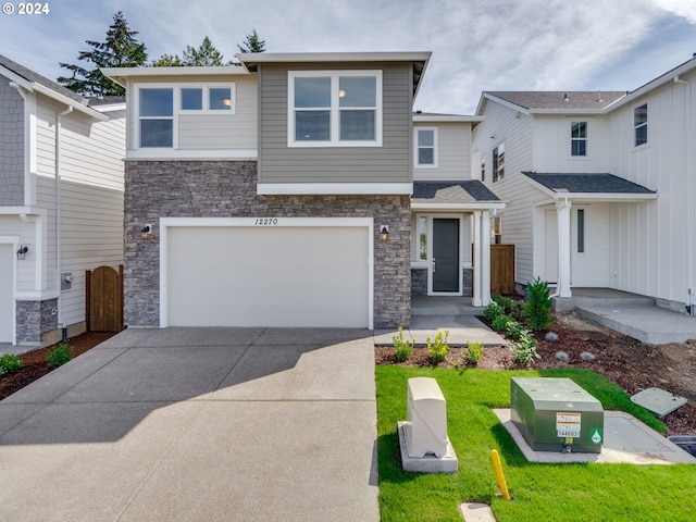 view of front of property featuring a garage and a front lawn