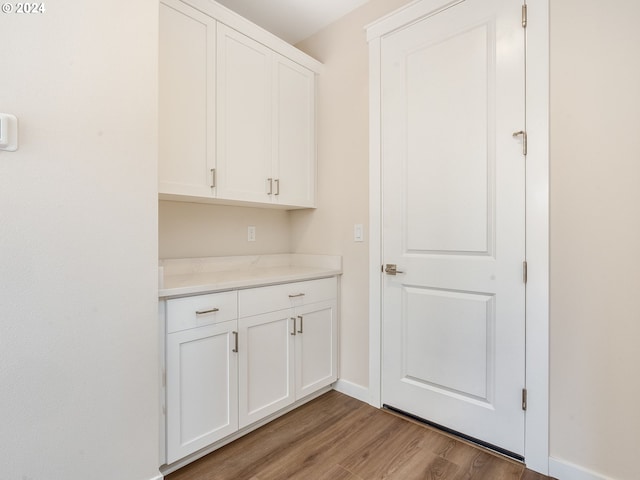 interior space with white cabinetry and light hardwood / wood-style floors