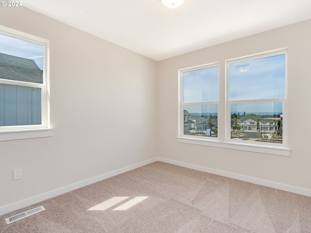 unfurnished room featuring carpet