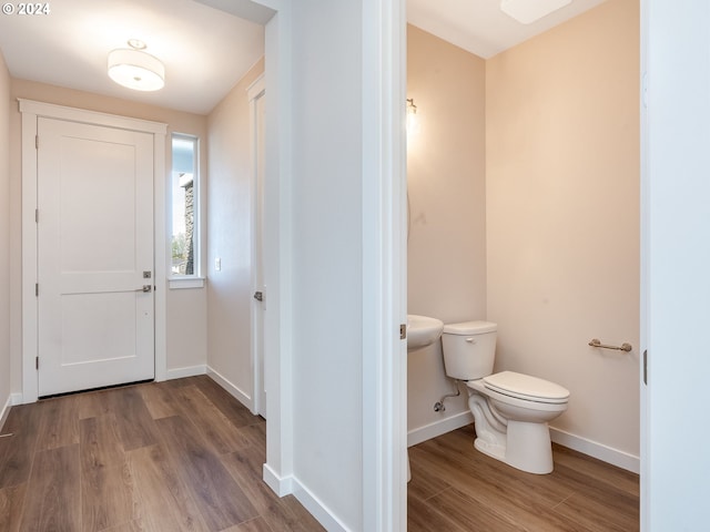 bathroom with hardwood / wood-style floors and toilet