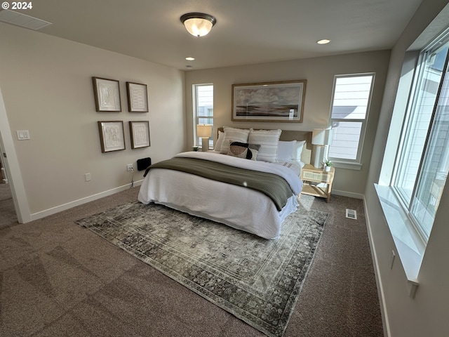 bedroom with dark colored carpet