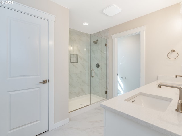 bathroom featuring vanity and a shower with shower door