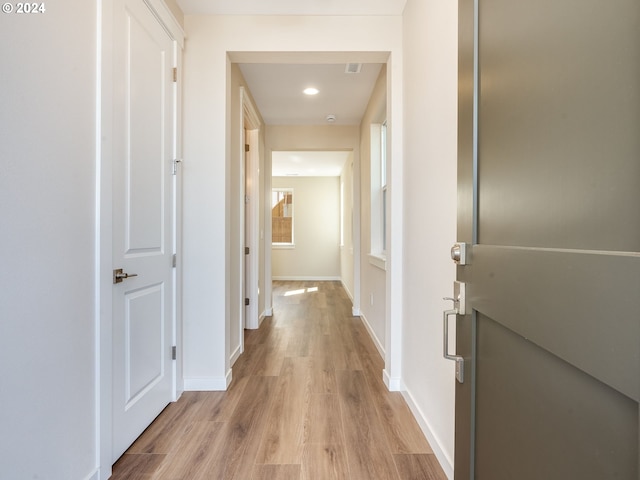 corridor with light wood-type flooring