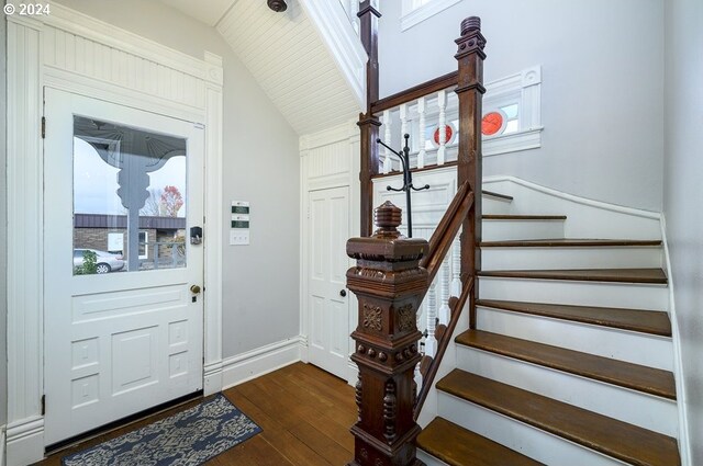 entrance foyer with plenty of natural light, dark hardwood / wood-style flooring, and lofted ceiling