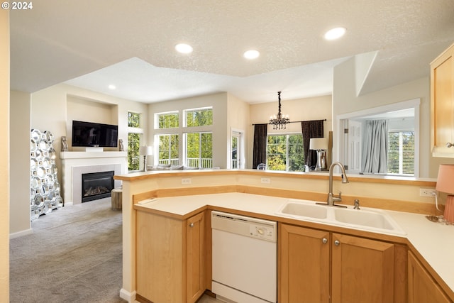 kitchen with light carpet, dishwasher, sink, and a textured ceiling