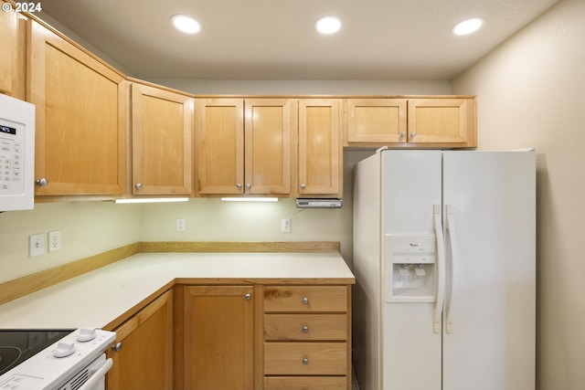 kitchen featuring white appliances and light brown cabinets