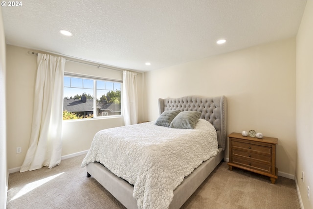 carpeted bedroom with a textured ceiling