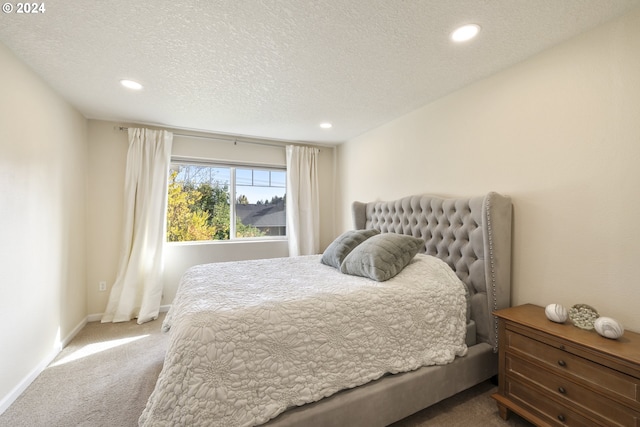 carpeted bedroom featuring a textured ceiling