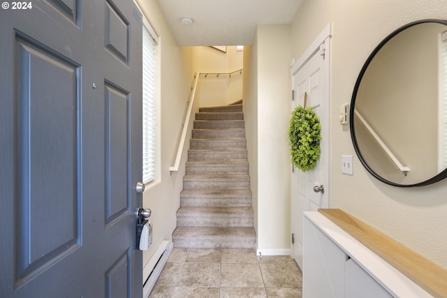 entrance foyer with a baseboard radiator and light tile patterned floors