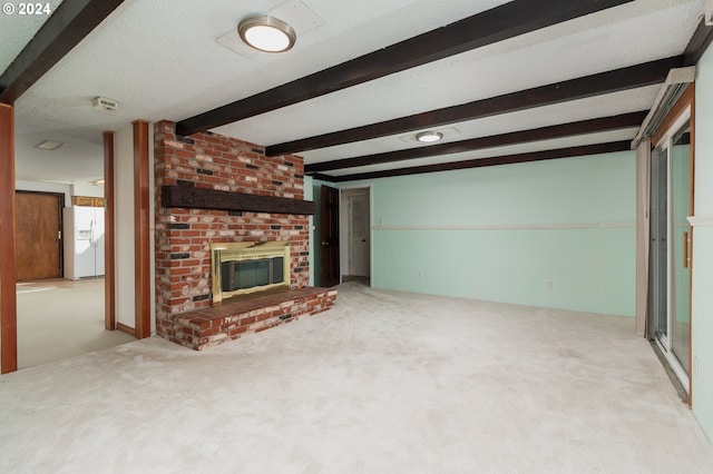 unfurnished living room with beam ceiling, a textured ceiling, light colored carpet, and a fireplace