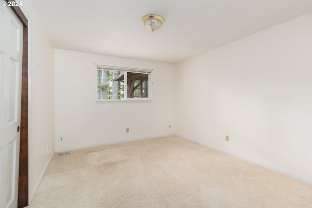 unfurnished bedroom with light colored carpet