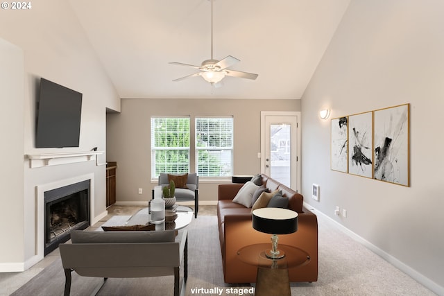 carpeted living room with high vaulted ceiling and ceiling fan