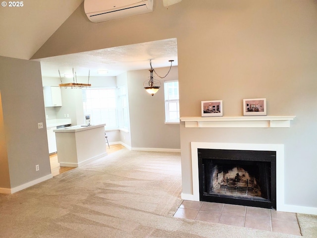 8550 SW Curry Dr Unit A, Wilsonville, OR 97070 - unfurnished living room with a wall mounted air conditioner, light carpet, a fireplace with flush hearth, and baseboards