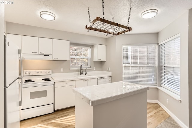 spare room featuring carpet, a textured ceiling, and a baseboard heating unit