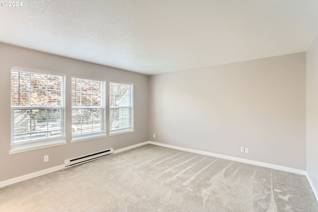8550 SW Curry Dr Unit A, Wilsonville, OR 97070 - empty room featuring baseboard heating, carpet floors, healthy amount of natural light, and a textured ceiling