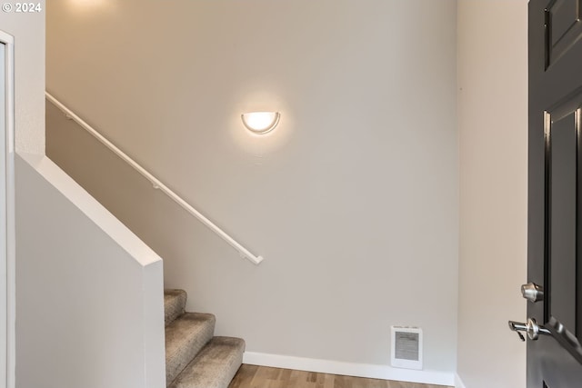 staircase featuring wood-type flooring