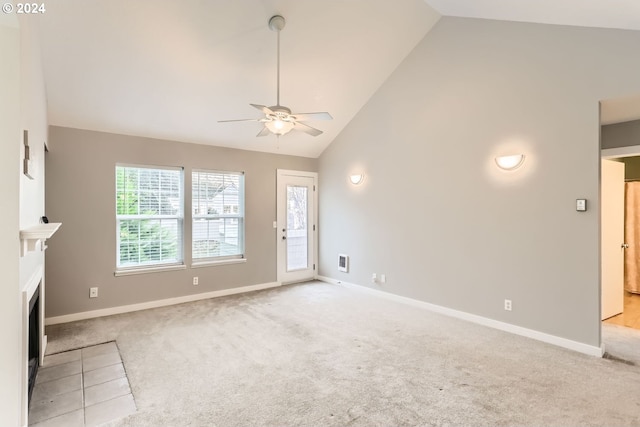 8550 SW Curry Dr Unit A, Wilsonville, OR 97070 - unfurnished living room featuring carpet flooring, ceiling fan, baseboards, high vaulted ceiling, and a fireplace with flush hearth