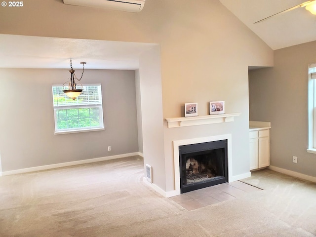 8550 SW Curry Dr Unit A, Wilsonville, OR 97070 - living room with light colored carpet, baseboards, a fireplace with flush hearth, lofted ceiling, and a wall unit AC