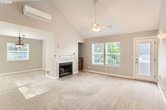 unfurnished living room featuring a wall mounted AC, a wealth of natural light, high vaulted ceiling, and light carpet