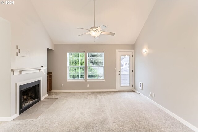 8550 SW Curry Dr Unit A, Wilsonville, OR 97070 - unfurnished living room with lofted ceiling, carpet, a ceiling fan, a fireplace with flush hearth, and baseboards