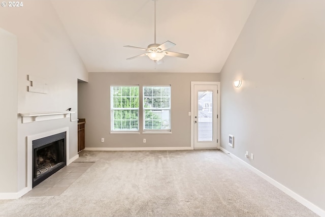 unfurnished living room featuring ceiling fan, high vaulted ceiling, and light carpet