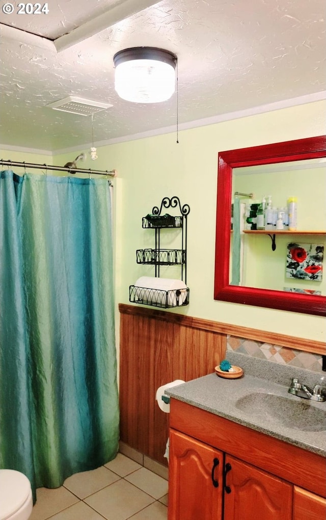 bathroom with curtained shower, wainscoting, a textured ceiling, vanity, and tile patterned flooring