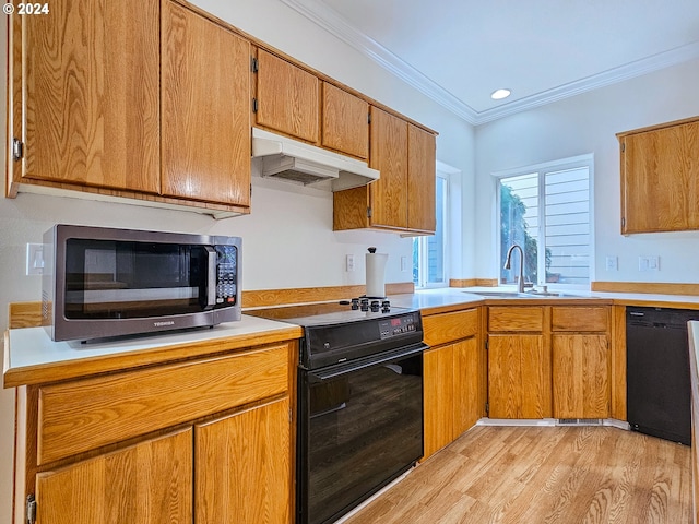 kitchen featuring crown molding, sink, black appliances, and light wood-type flooring