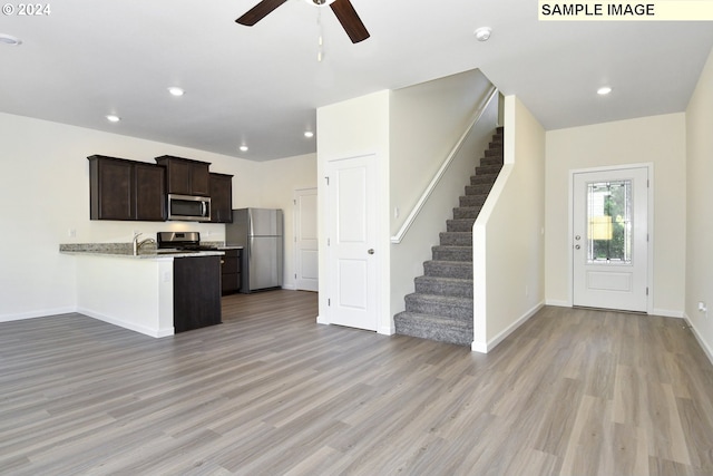 kitchen with ceiling fan, appliances with stainless steel finishes, kitchen peninsula, and light hardwood / wood-style flooring