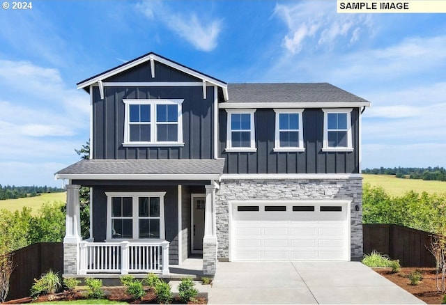 craftsman-style house with a garage, covered porch, and a rural view