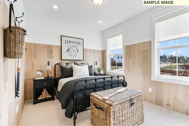 carpeted bedroom with wood walls