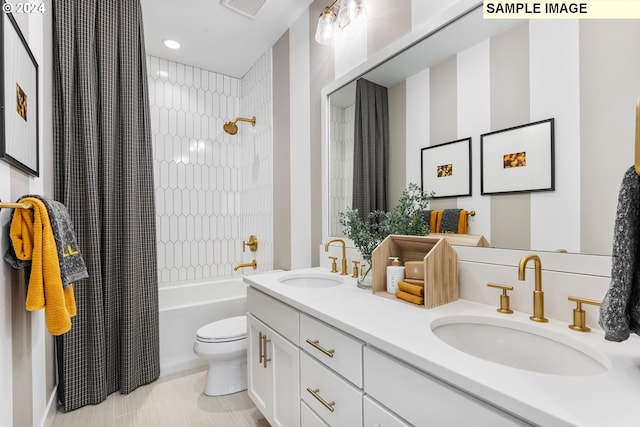 bathroom featuring visible vents, a sink, toilet, and double vanity