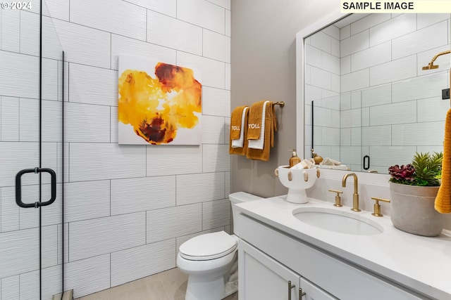 bathroom featuring vanity, toilet, and a shower with door