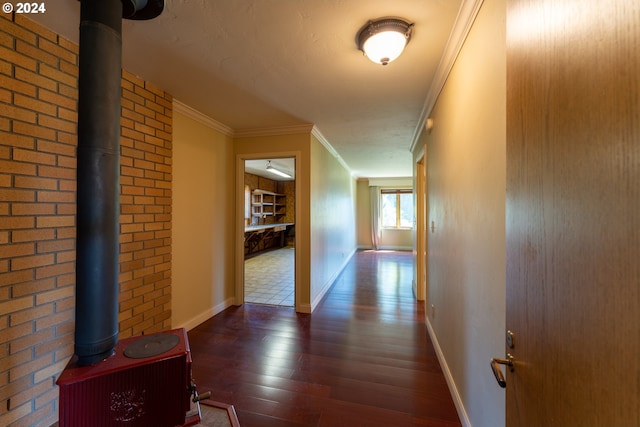 hall with dark hardwood / wood-style flooring and ornamental molding